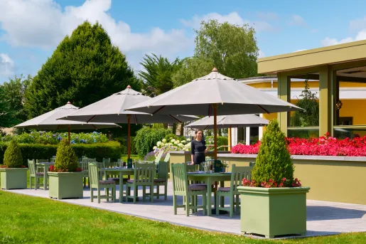 Outdoor seating area with chairs , tables and umbrellas