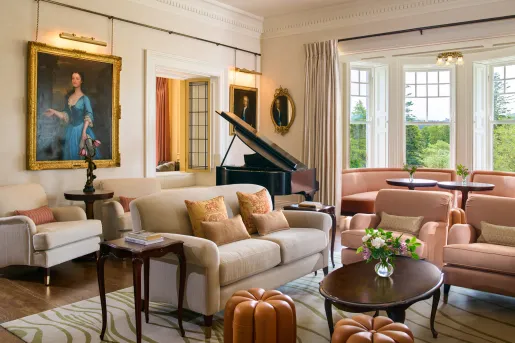 Lobby with cushioned couches and a piano in the back