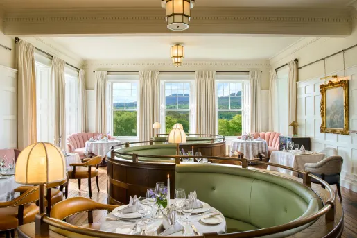 Half-circle shaped seating booths with a dining table in the center