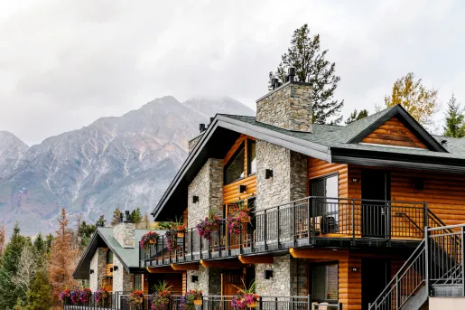 Wooden and stone cabin-styled building with flowers along the railings