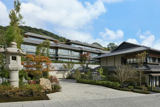 Japanese-style hotel building with stone statues in the courtyard