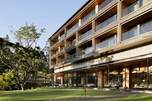 Exterior of a multi-story building with glass balconies on each level
