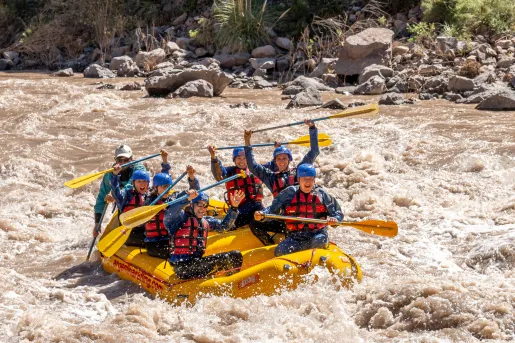 group of people white water rafting