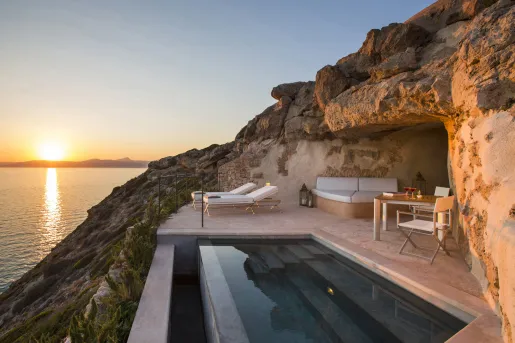 pool deck overlooking sunset on the water