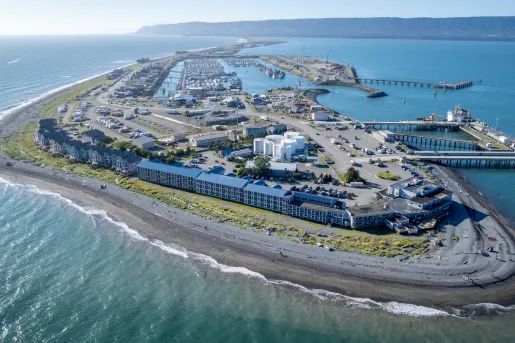 Peninsula of long hotel buildings next to the ocean