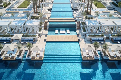 large swimming pool with decks and lounge chairs throughout 