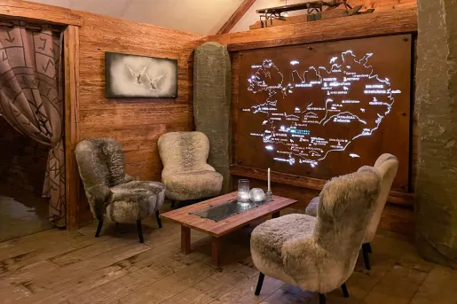 fur covered chairs around a table with a map on the wall