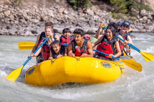 teens on a raft in the river