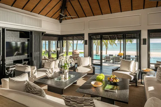 large living room with couches surrounding coffee tables