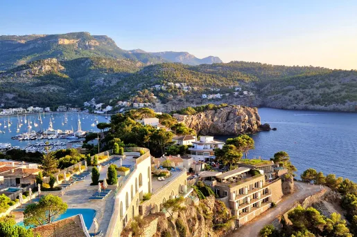 Exterior, skyview of hotel building with rooftop patios and a lake on the right