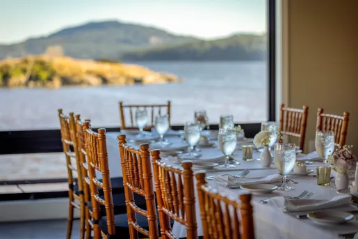 long dining room table with a view of the water