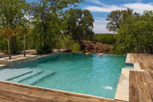 Outdoor pool with two people looking out to the mountains