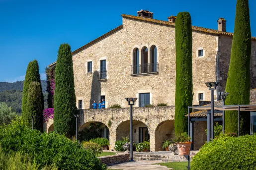 Stone house surrounded by green trees
