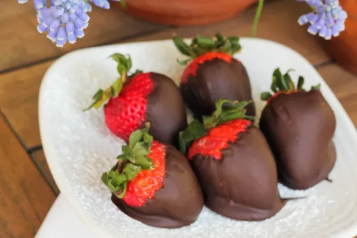 Chocolate covered strawberries on a white plate