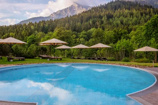 Large swimming pool surrounded by sun umbrellas