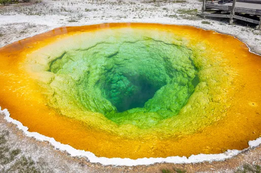 Orange and green puddle leading to a hole in the ground
