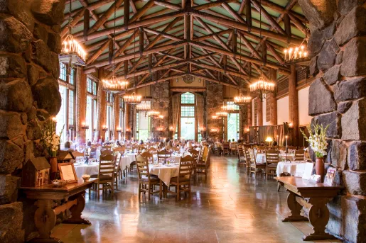Indoor dining hall with tall wooden and stone pillars