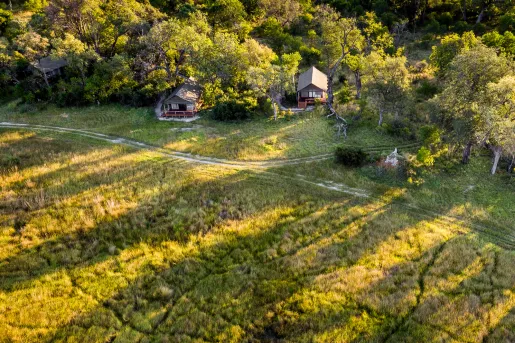 grassy fields with small cottages