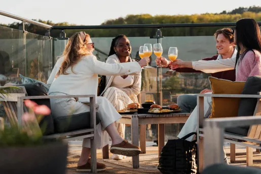 friends cheers wine glasses on a patio