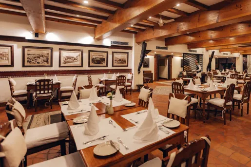 Dining hall with wooden walls and folded handkerchiefs on each table