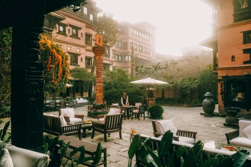 Outdoor courtyard with a waiter cleaning outdoor tables