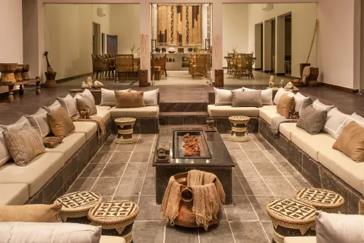 Indoor lounge with a large, square shaped seating area with cushioned sofas