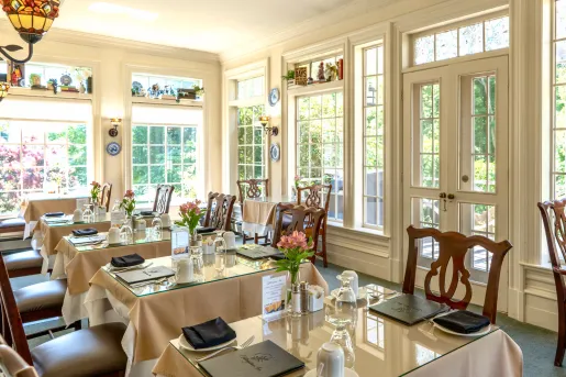 Indoor dining area with glass dining tales and wooden chairs