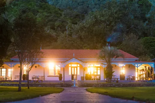 Lights coming out of a hotel building with a tall mountain behind it