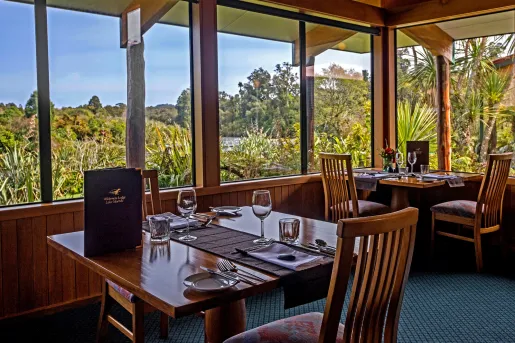 Dining room with wooden chairs and tables, and a menu on the table