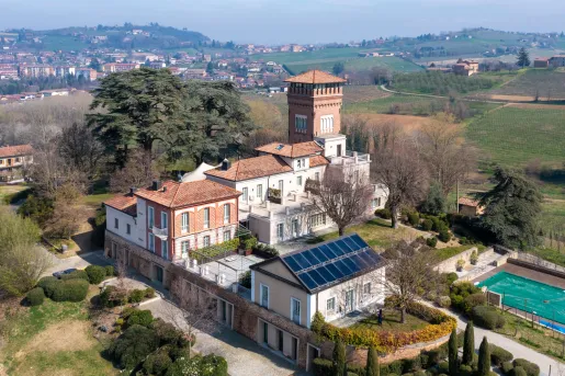Exterior sky view of stone and brick buildings with an outdoor pool
