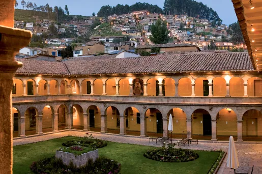 lit up hotel surrounded by houses