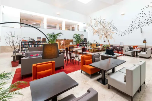 lobby with bookshelves and chairs and couches