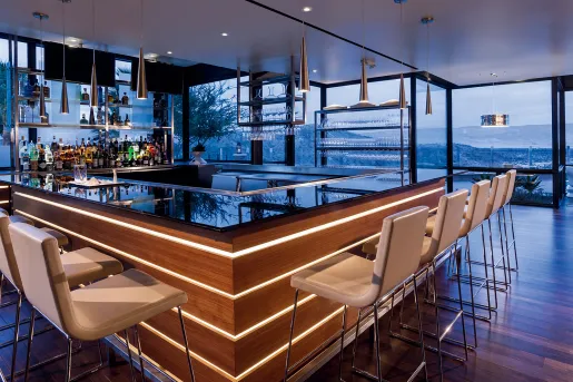 Indoor bar with white stools and marble counters