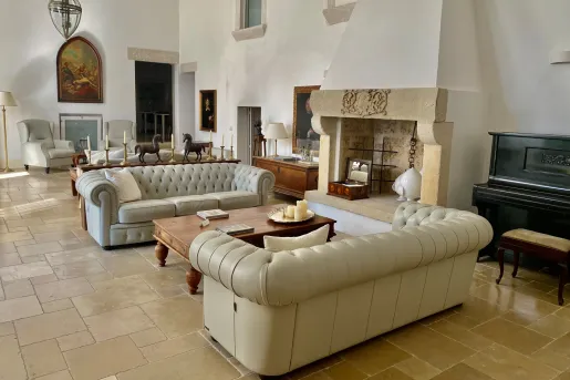 white leather couches in living room with fireplace