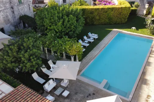 hotel swimming pool surrounded by lounge chairs