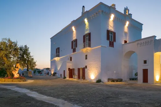 White stone building  with orange lights along the walls