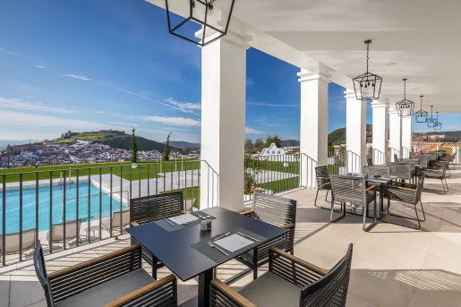 Outdoor chairs and tables overlooking the outdoor pool