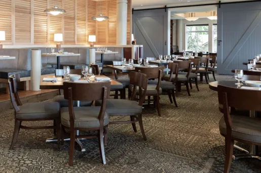 Indoor dining area with cushioned chairs and circular booths
