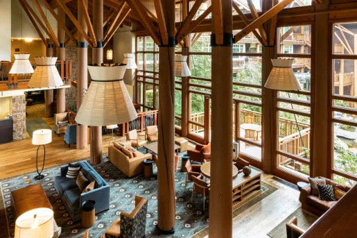 Indoor lobby with wooden pillars and cushioned couches
