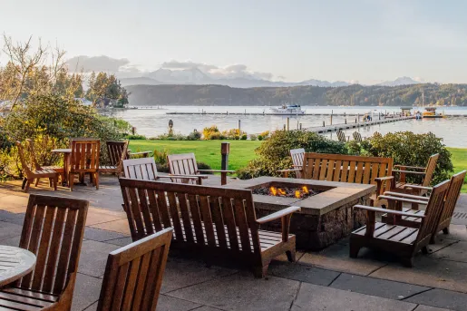 Wooden chairs around stone fire pits outdoors