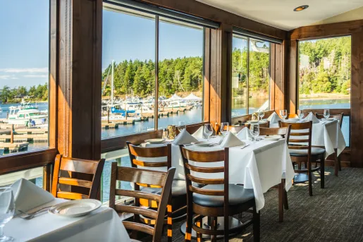 Indoor dining room with table cloths and wine glasses on each table