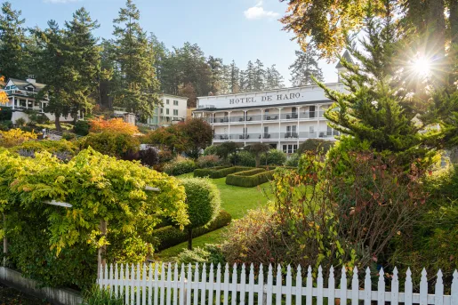 Hotel exterior, with a garden and white picket fence in front