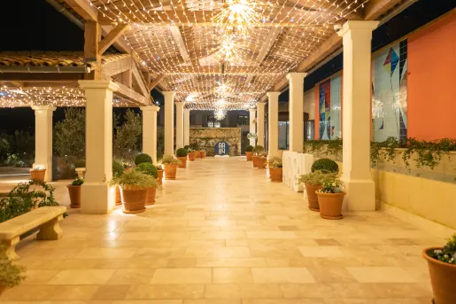 Stone outdoor walkway with string lights on the ceiling