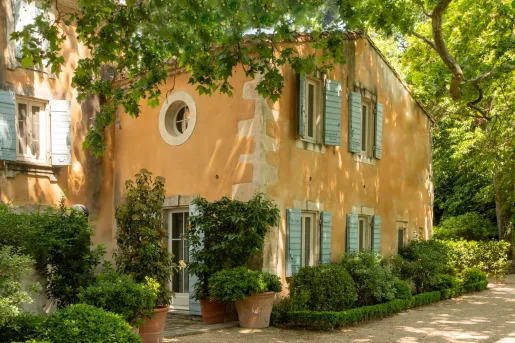 yellow house tucked in the trees
