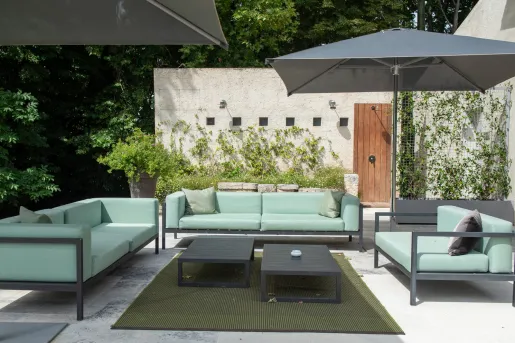 Outdoor patio with blue couches and gray umbrellas