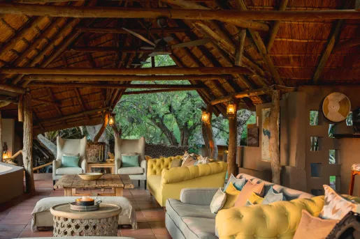 Open air lounge under a wooden hut-style roof