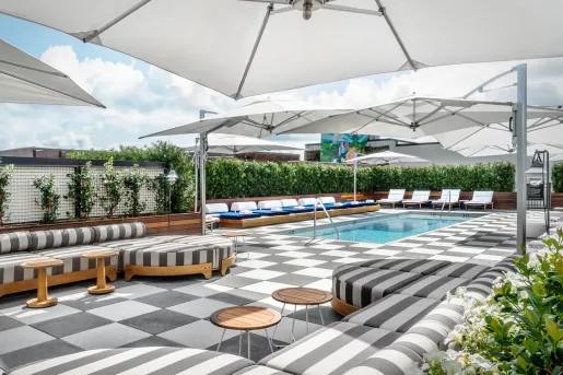 pool deck with lounge furniture and umbrellas
