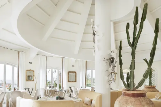 Dome-shaped room with a white pillar and chairs around each table