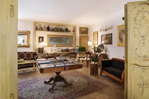 Library room with a big, square table and cushioned sofas