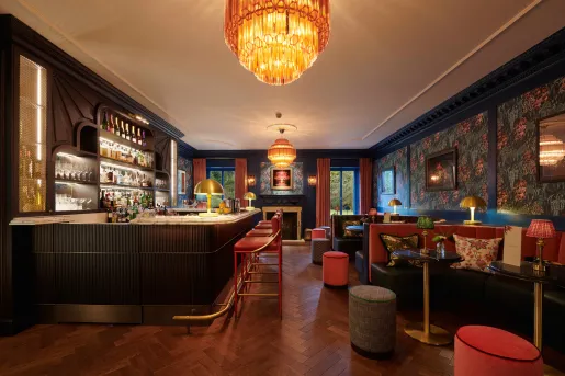 dark hotel bar with large chandelier